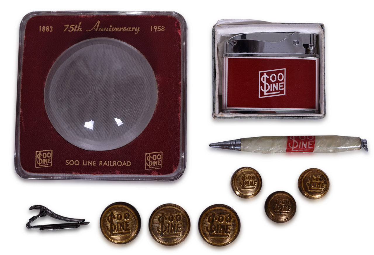 8630 - Group of Nine Soo Line Railroad Items - Buttons, Glass Anniversary Paperweight, Lighter, Pencil, and Tie Clip thumbnail