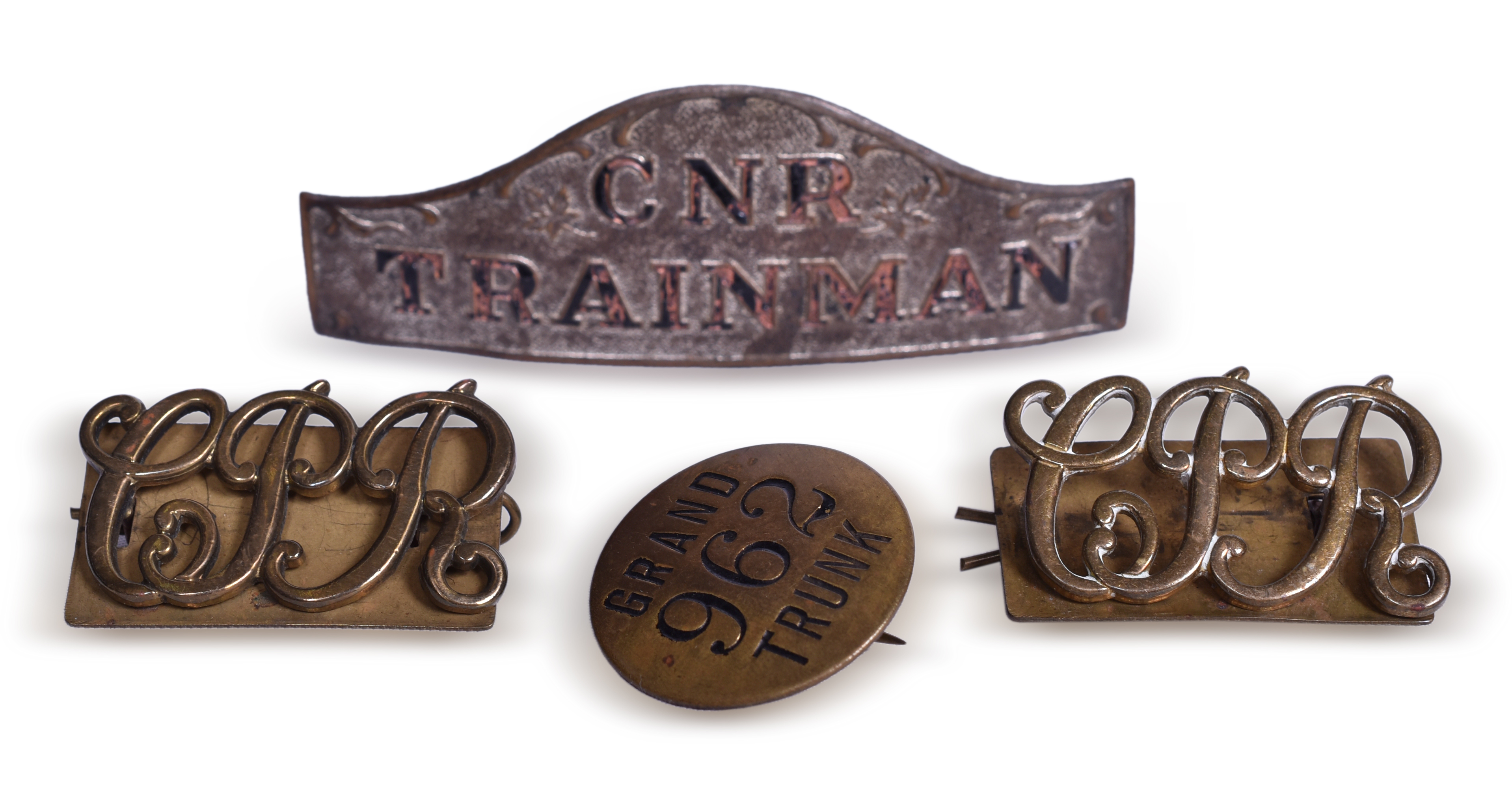 2139 - Four Canadian Railroad Uniform Items - Canadian National Trainman Badge, Canadian Pacific Lapel Pins, and Grand Trunk Pin thumbnail