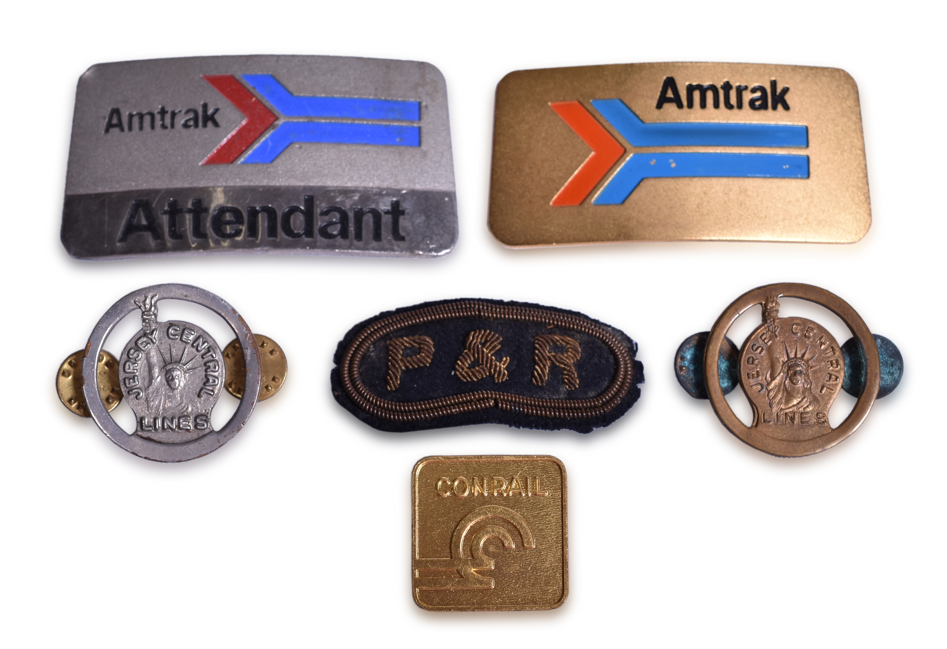 2143 - Mixed Group of Eastern Railroad Uniform Cap Badges, Patches, and Pins - Amtrak, Jersey Central Lines, Philadelphia & Reading, and Conrail thumbnail