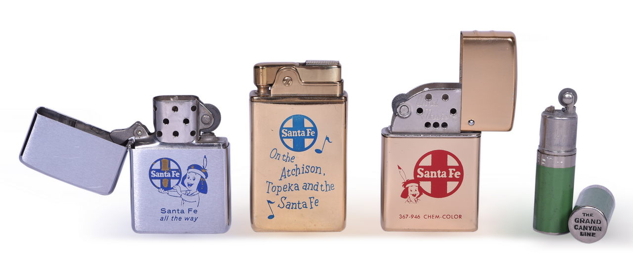 2627 - Four Santa Fe Railroad Lighters - Crown Musical Lighter, Zippo, Mighty Midget, and Wind Master thumbnail