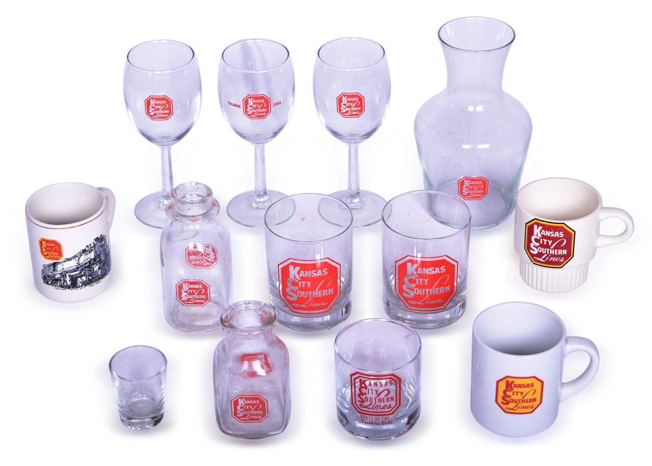 4295 - Thirteen Pieces of Kansas City Southern Railroad Glassware - Carafe, Wine Glasses, Shot Glass, Milk Bottles, and Mugs thumbnail