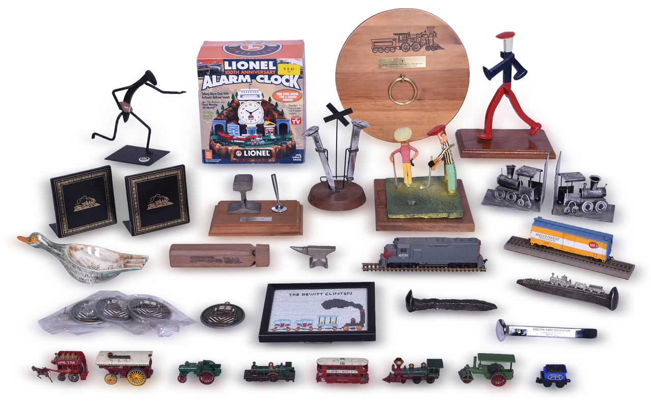 5273 - Large Group of Railroad Ephemera - Spike Sculptures, Seaboard Sun Catchers, Lionel Alarm Clock, Paperweights, Bookends, and More thumbnail