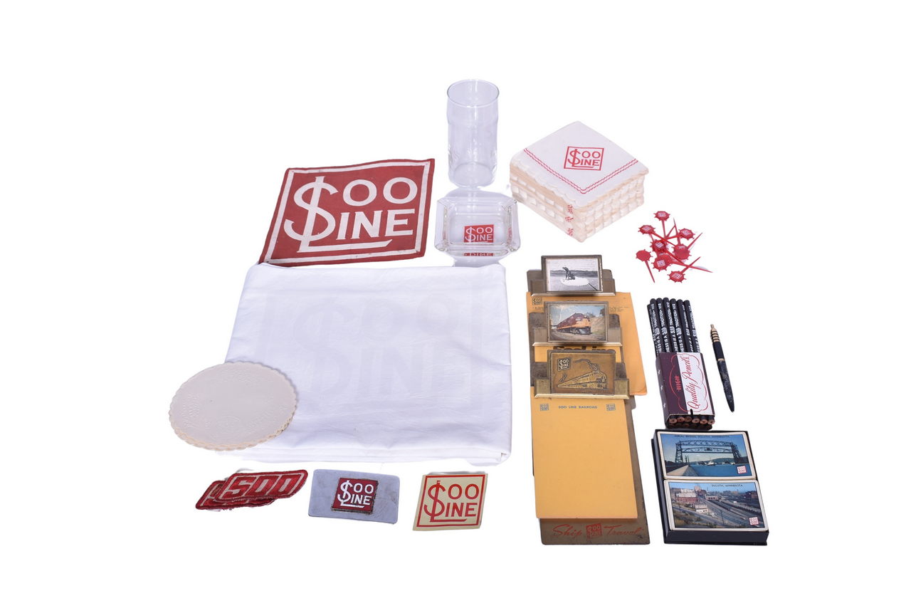 1633 - Mixed Group of Soo Line Railroad Ephemera - Clipboards, Linen Tablecloth, Drinking Glass, Ashtray, Patches, Etc. thumbnail