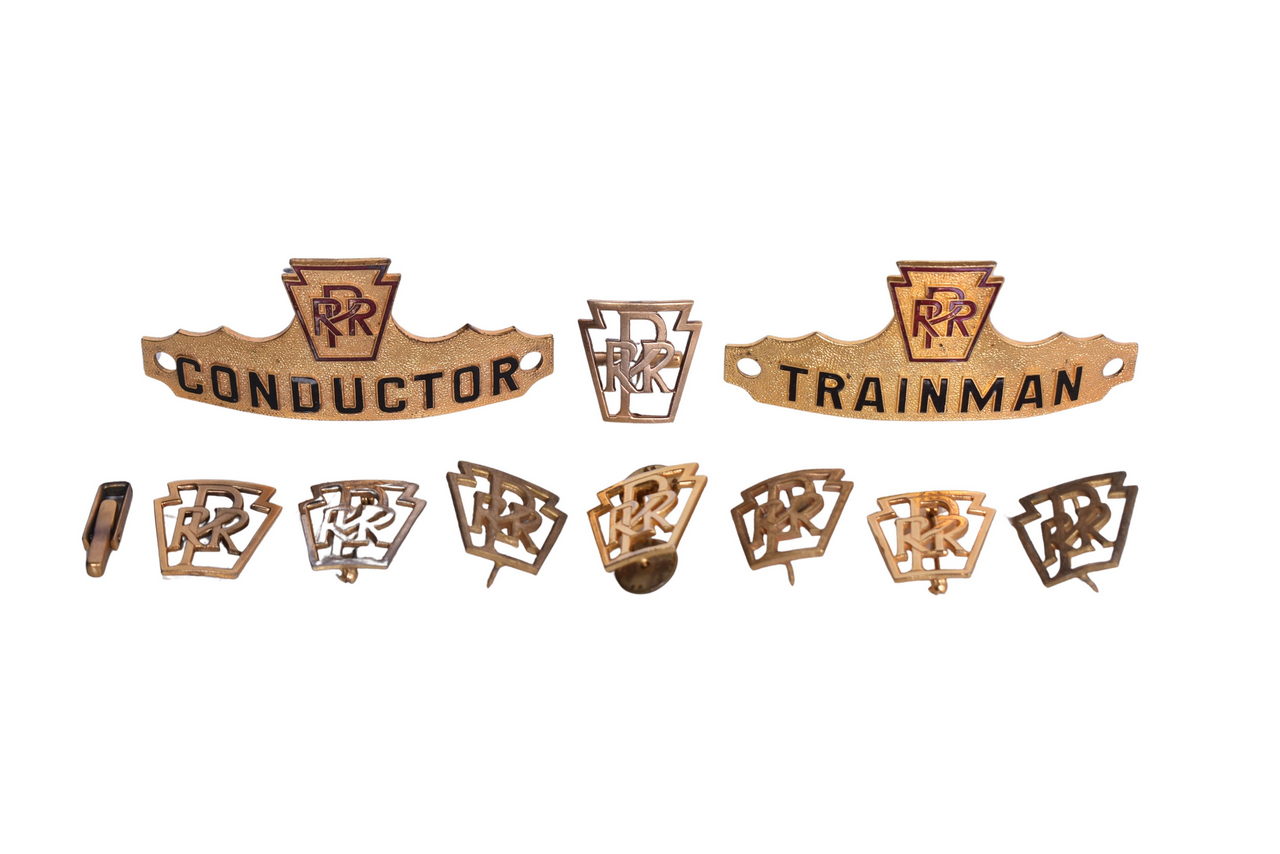 6241 - Group of Pennsylvania Railroad Cap Badges, Conductors Lapel Pins, and Cuff Links thumbnail