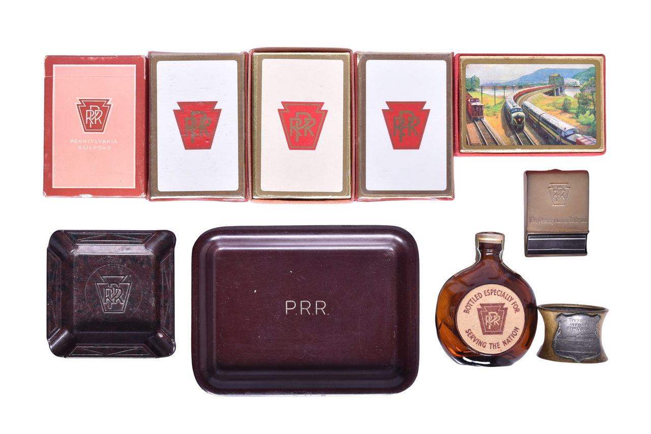 6677 - Group of Pennsylvania Railroad Items - Old Forester Bottle, Brass Match Case, Sealed Playing Cards, Ashtrays, and Souvenir thumbnail
